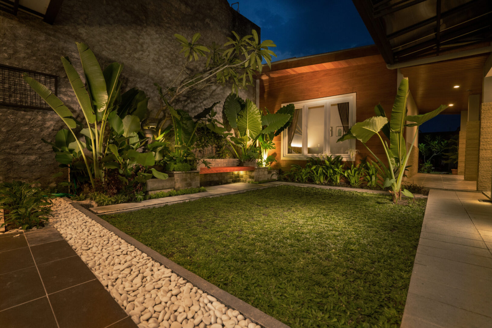 Tropical Backyard Garden at Night with Various of Plants